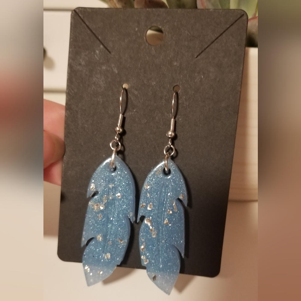 Handmade blue feather earrings.